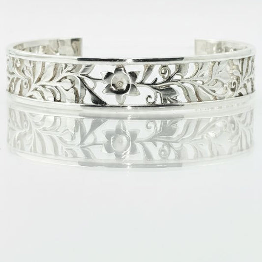 "Close-up sterling silver floral vine cuff bracelet with detailed engraved pattern"