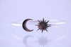 “925 sterling silver moon and sun open cuff bracelet, front view on a white background.”