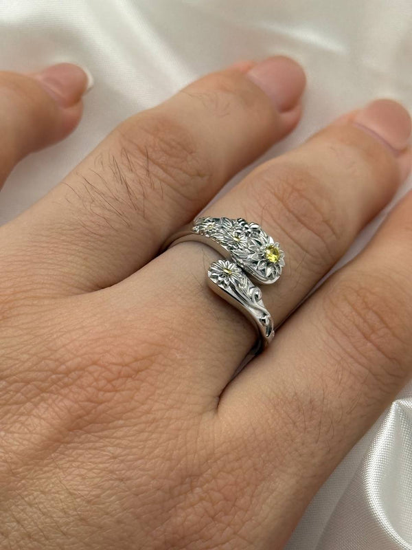 Adjustable sterling silver floral ring with yellow zircon shown on hand
