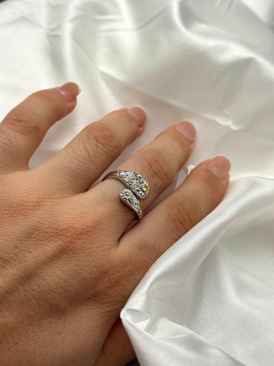 Adjustable sterling silver floral ring with yellow zircon shown on hand