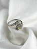 Sterling silver adjustable floral ring with yellow zircon shown in an open botanical design