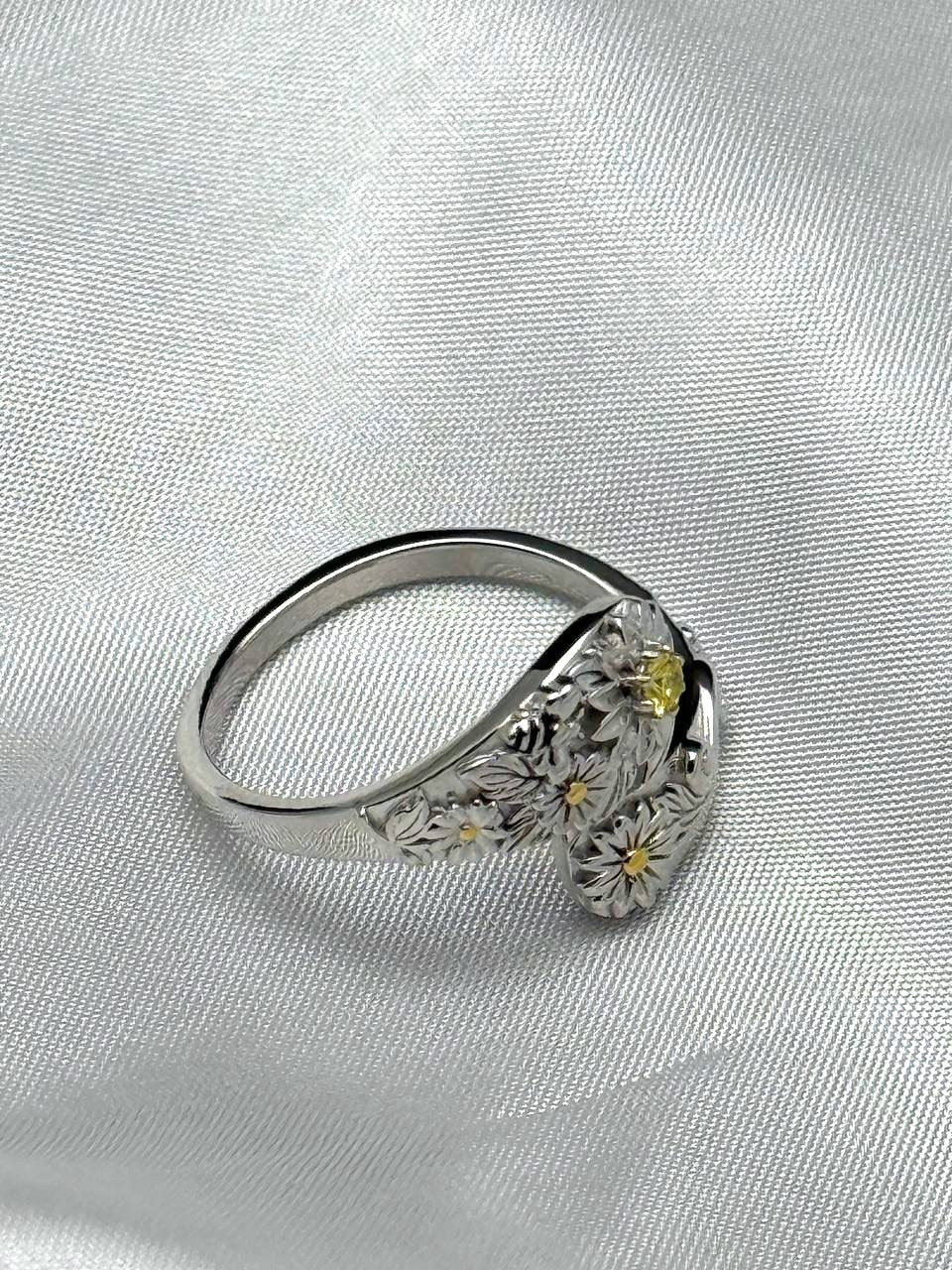 Side view of adjustable sterling silver floral ring with yellow zircon and sculpted flower details
