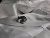 Artisan silver dragon ring with detailed scales and black oxidation on a white silk fabric background.