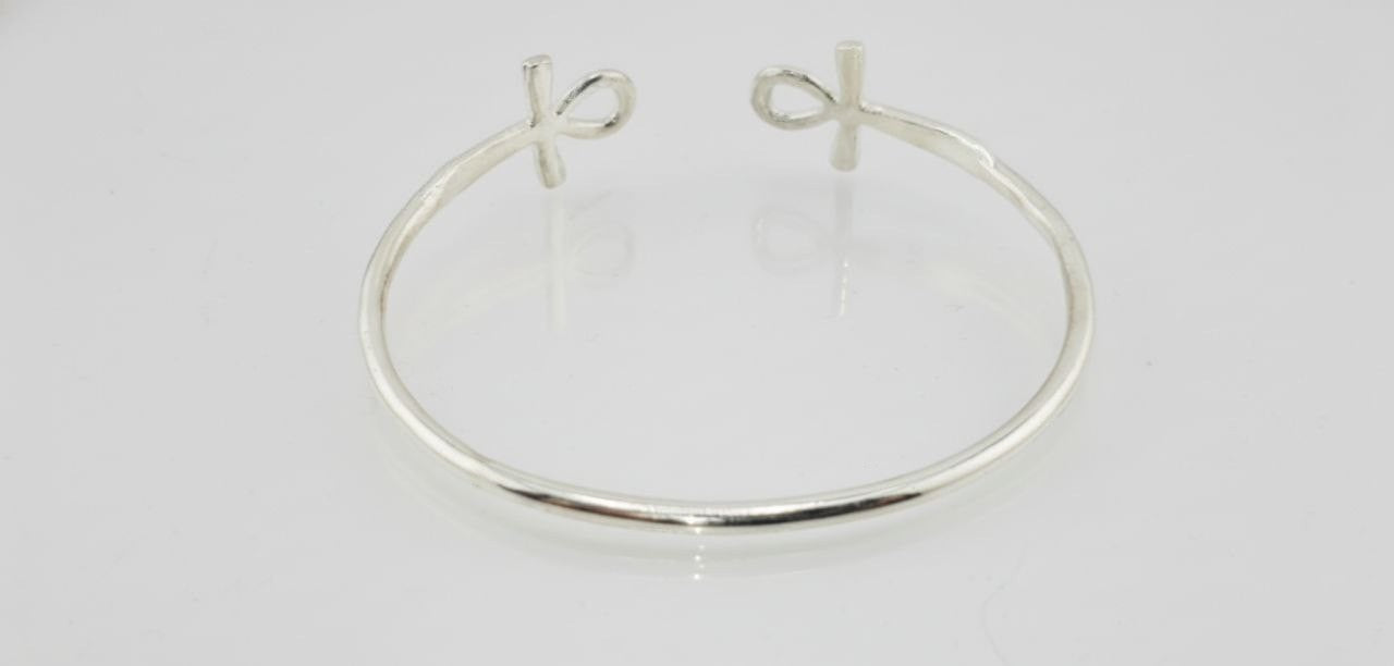 “Sterling silver Ankh open cuff bracelet on a white background”