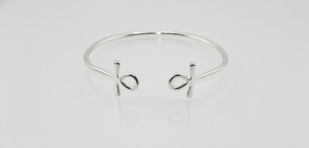 “Sterling silver Ankh cuff bracelet on a white background”