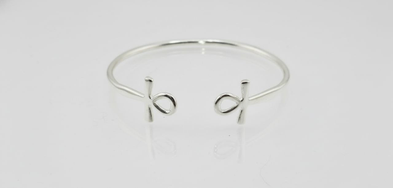 “Sterling silver Ankh cuff bracelet on a white background”
