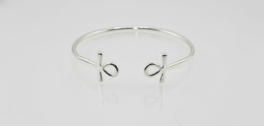 “Sterling silver Ankh cuff bracelet on a white background”