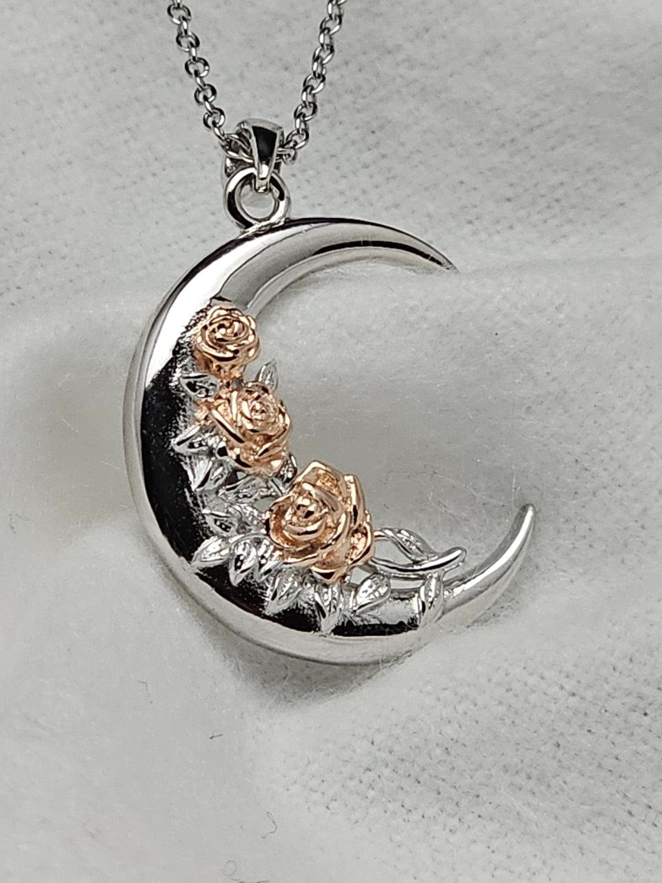 925 sterling silver crescent moon necklace with warm-toned sculpted roses and silver leaf details.