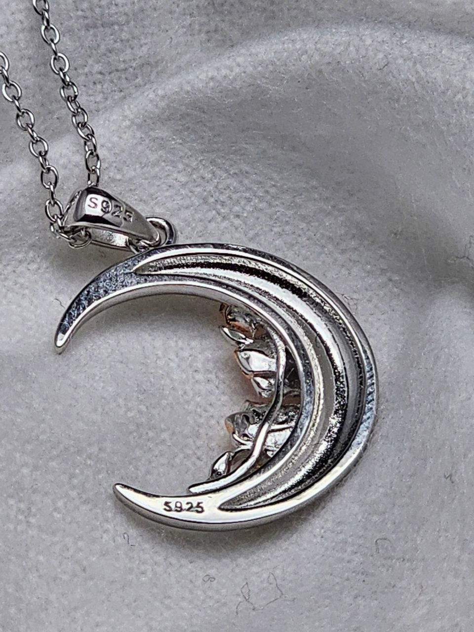 Back view of the crescent moon necklace showing S925 sterling silver hallmarks on the pendant and bail.