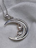 Back view of the crescent moon necklace showing S925 sterling silver hallmarks on the pendant and bail.