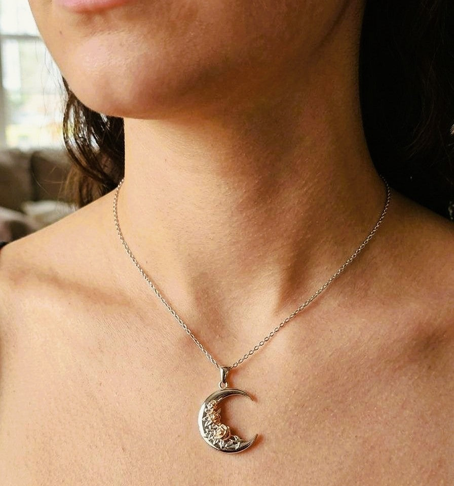 Crescent moon rose 925 sterling silver necklace worn on the neck.