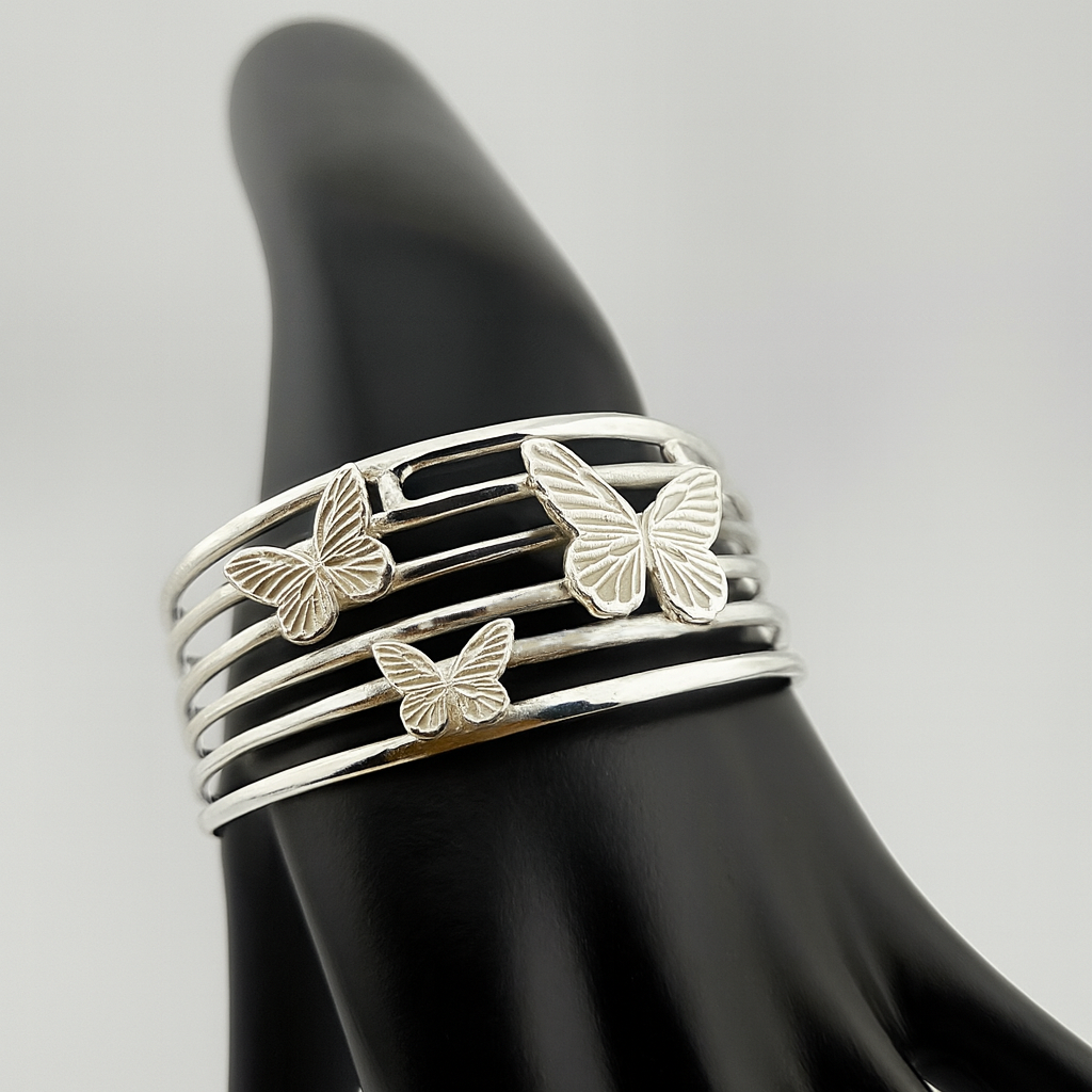 "Silver butterflies cuff bracelet — artisan 925 silver bangle with three butterfly motifs, handcrafted jewelry, unique gift for her."