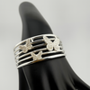 "925 sterling silver butterfly cuff bracelet with three sculpted butterfly motifs — openwork silver bangle on display."