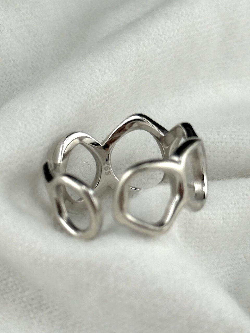 Close-up of Flowing Circle ring showing the 925 sterling silver hallmark