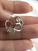 Close-up of a polished sterling silver ring with flowing open circle design