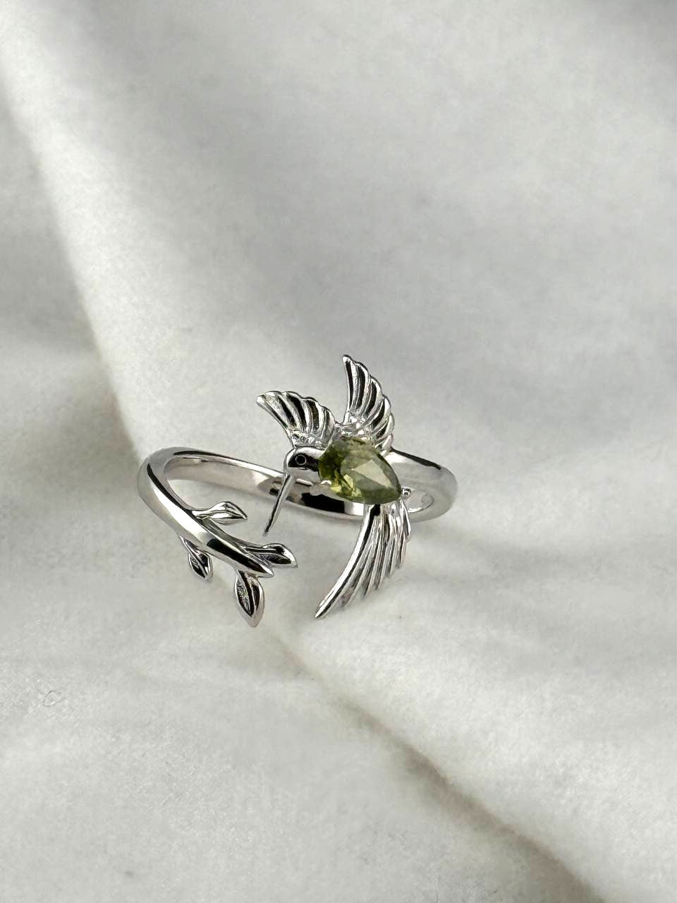 925 sterling silver hummingbird ring with a pear-shaped green zircon and leaf branch design.