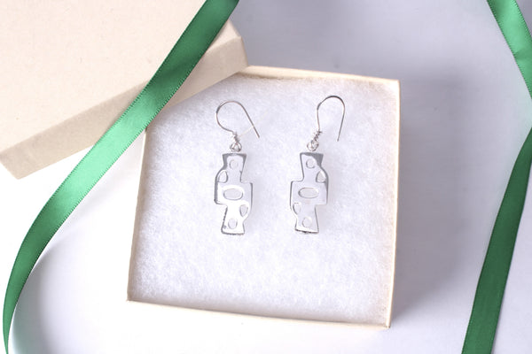 Sterling silver Gye Nyame Adinkra symbol earrings displayed in a gift box