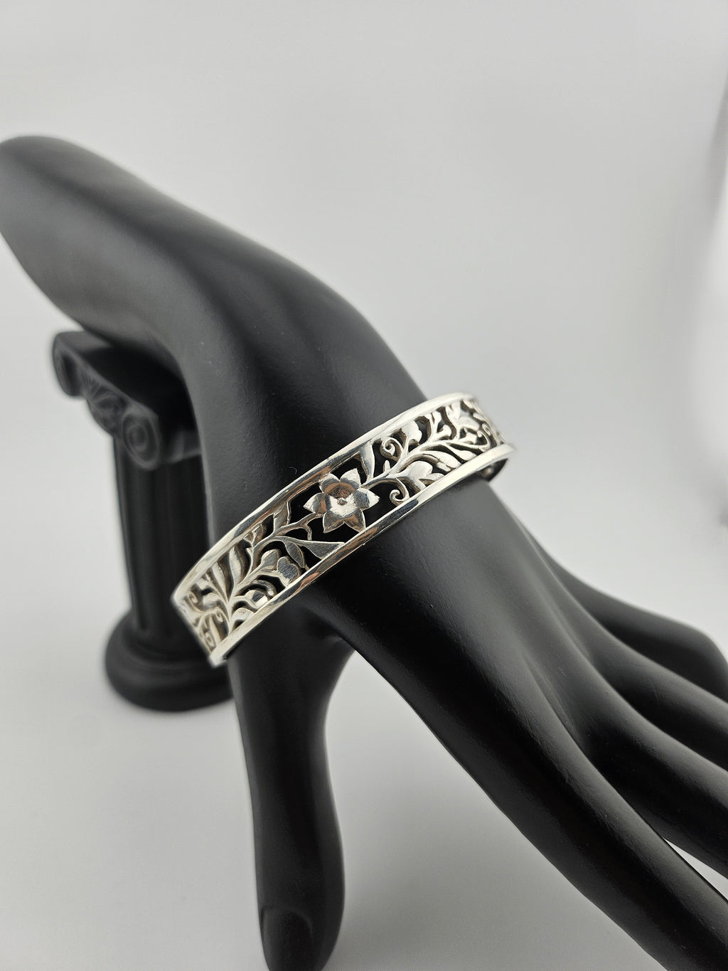 "Sterling silver floral vine cuff bracelet on black mannequin hand"