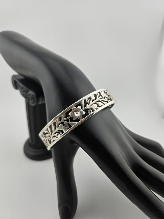 "Sterling silver floral vine cuff bracelet on black mannequin hand"