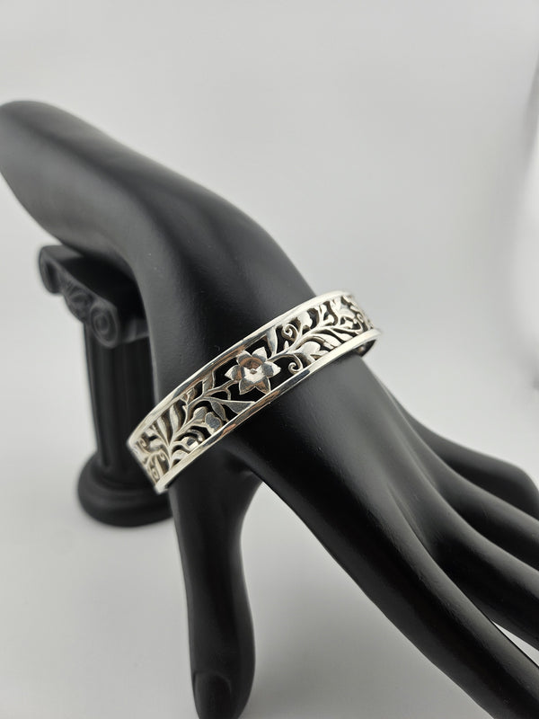 "925 sterling silver floral vine cuff bracelet displayed on black mannequin hand — Lakseena Jewelry"