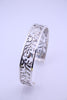 "Sterling silver floral vine cuff bracelet shown upright with detailed engraved pattern on white background"