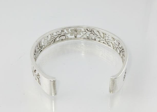 "Interior view of sterling silver floral vine cuff bracelet showing detailed engraved pattern on white background"