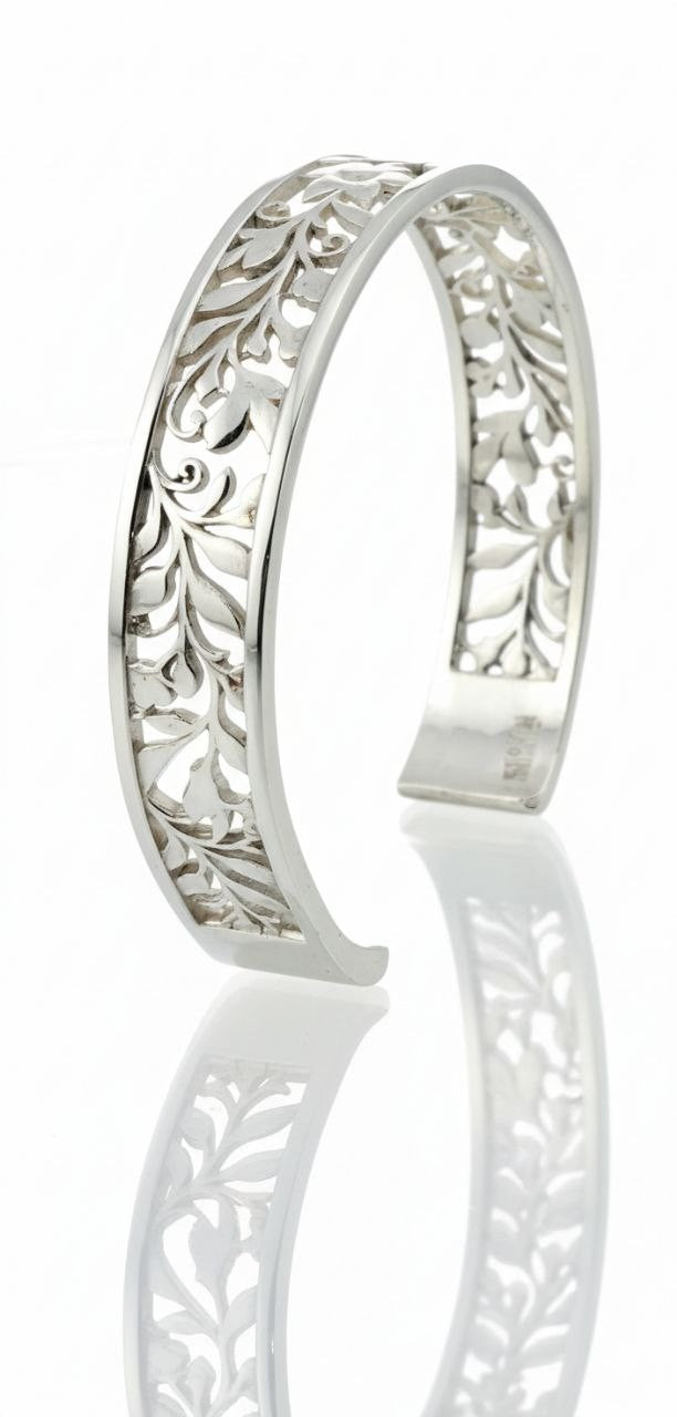 "Sterling silver floral vine cuff bracelet in angled view showing openwork leaf pattern on white background"