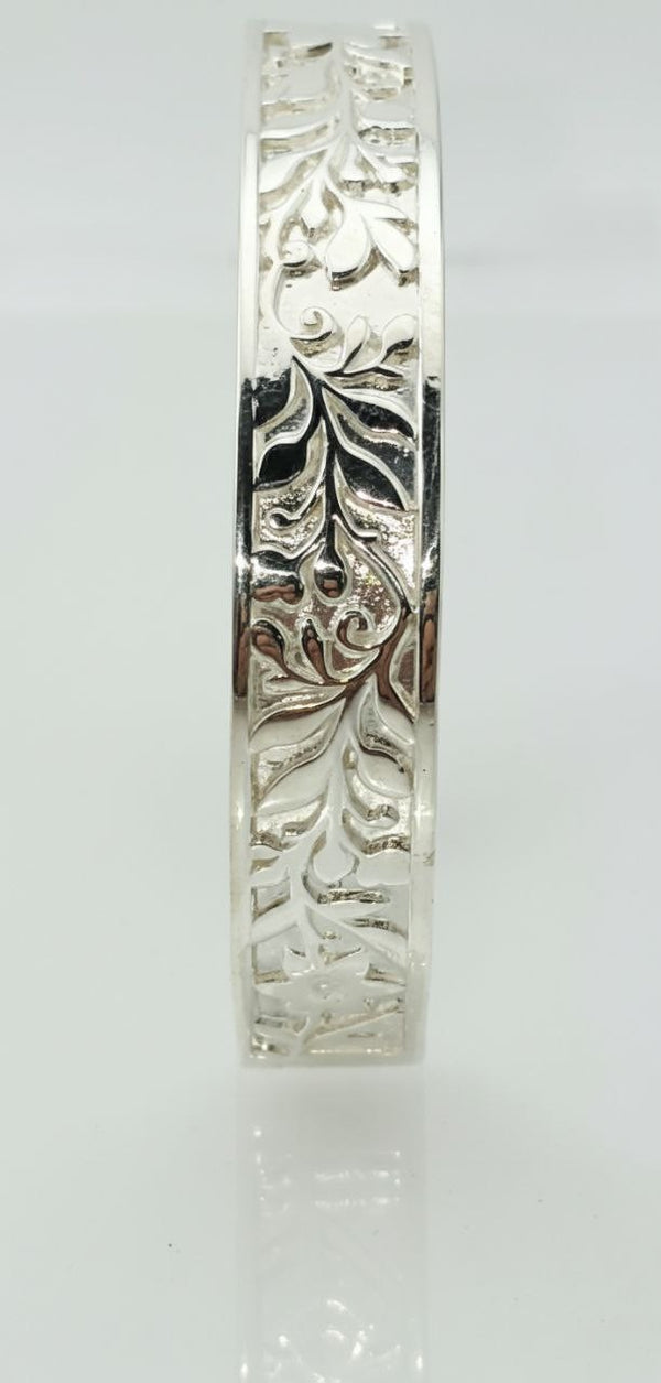 925 sterling silver cuff bracelet with floral and leaf pattern, close-up on a white background.