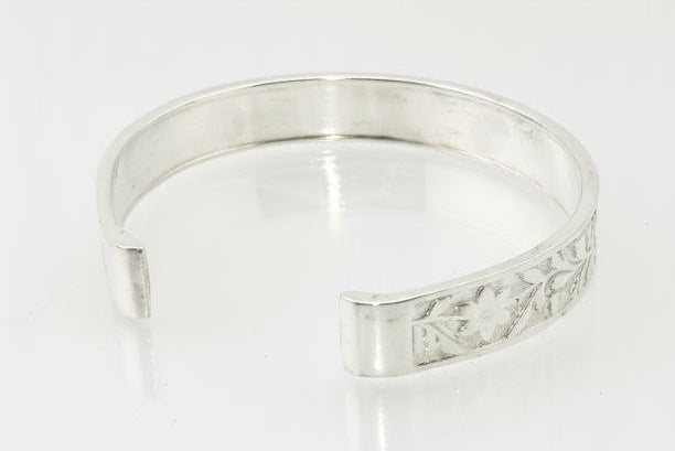 "Back view of the royal silver cuff bracelet showing the smooth polished inner surface, floral flower pattern edges and clean white background — luxury sterling silver jewelry."