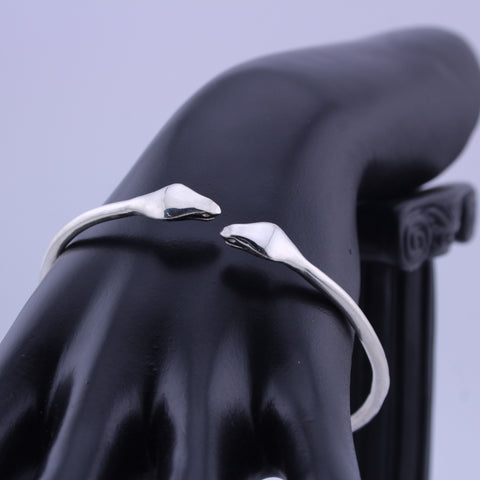 "925 sterling silver cuff bracelet with twin sculpted serpentine design on black display hand."