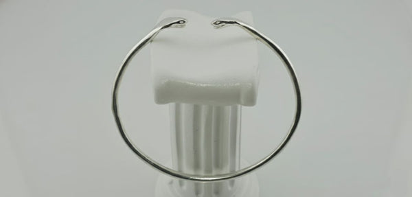 "Side view of 925 sterling silver cuff bracelet with twin sculpted serpentine design on white background."