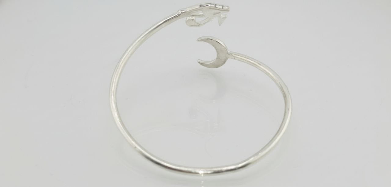 “Sterling silver Horus eye cuff bracelet — back view showing crescent moon detail.”
