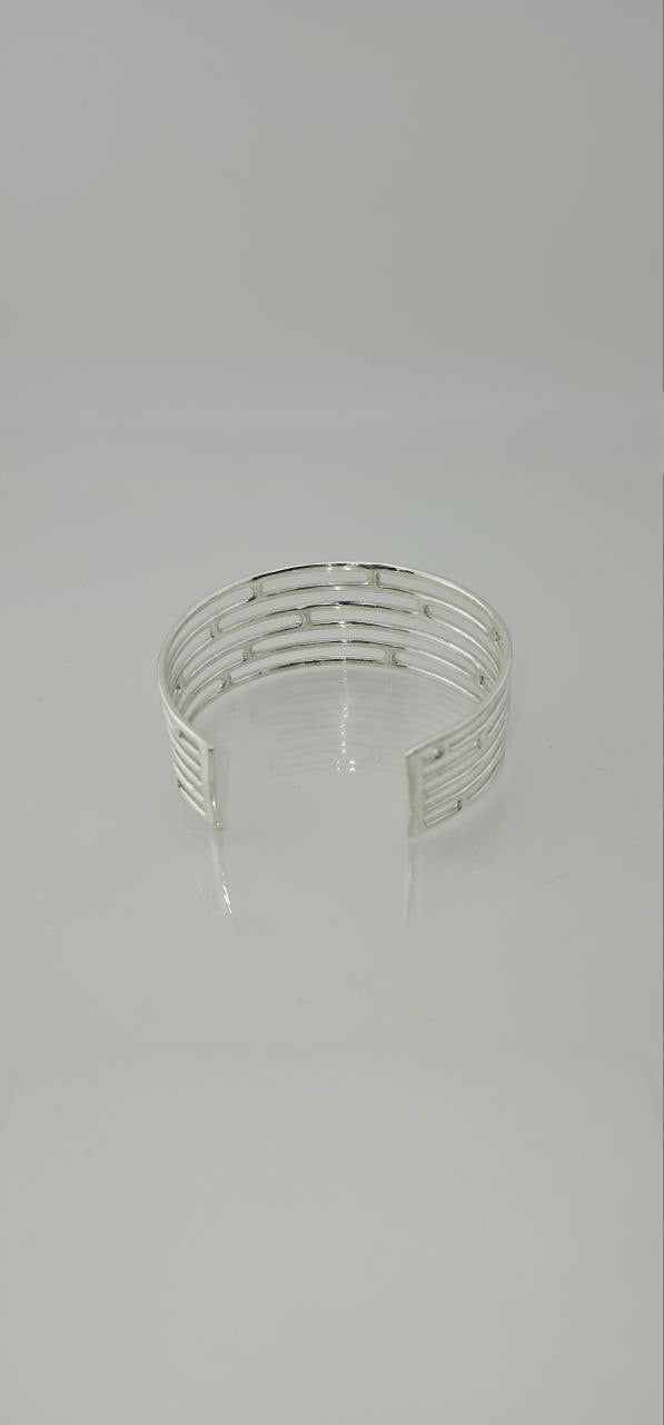 Top view of sterling silver openwork cuff bracelet with multi-band design