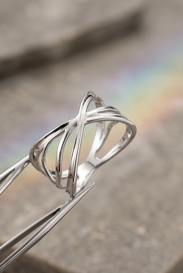 Close-up of mirror-polished silver ring, realistic metallic glow, precision 3D printed jewelry.