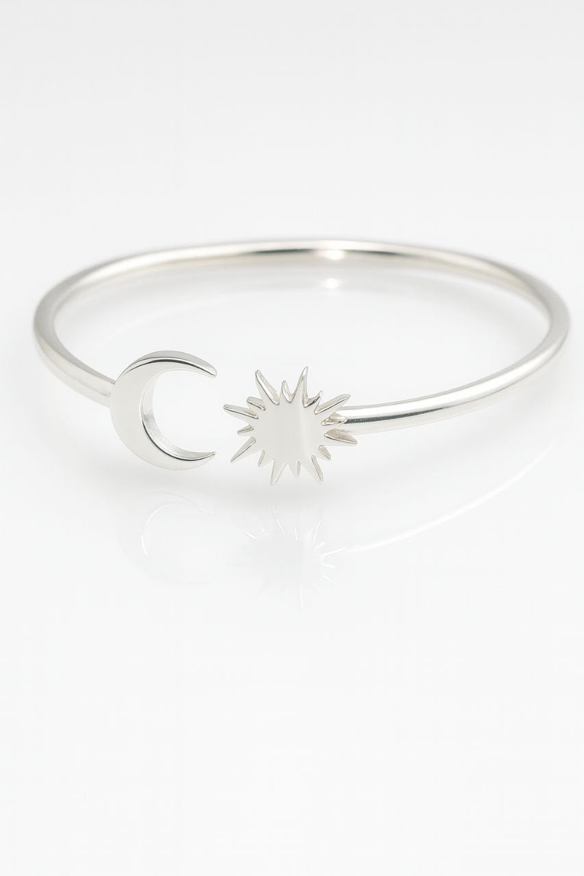 “925 sterling silver moon and sun cuff bracelet top view on a white background.”