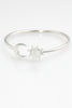 “925 sterling silver moon and sun cuff bracelet top view on a white background.”