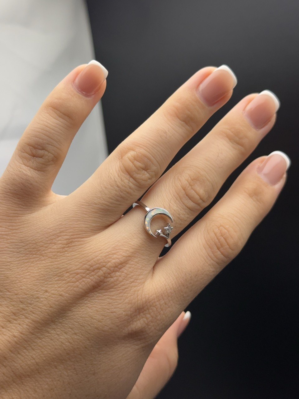 Sterling silver opal moon and stars ring shown on hand for scale