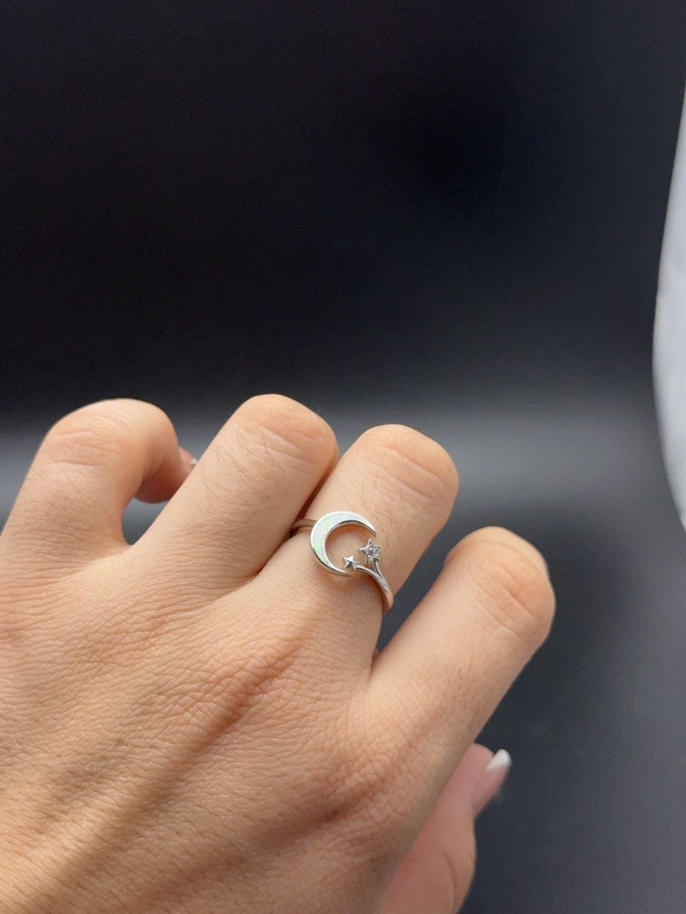 Sterling silver opal crescent moon and stars ring worn on finger