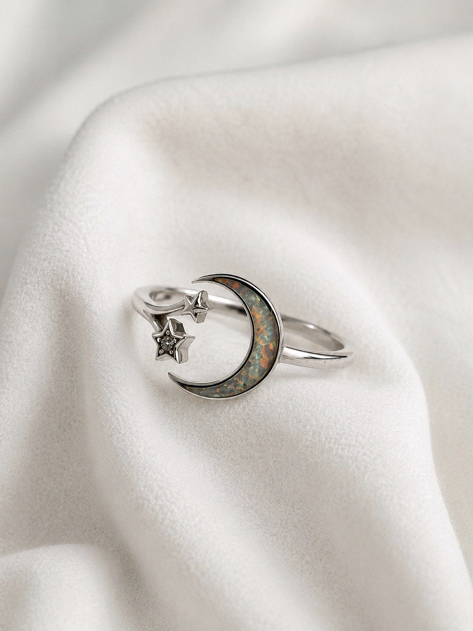 Front view of sterling silver crescent moon and stars ring with colorful opal inlay
