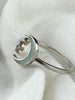 Side view of sterling silver crescent moon and stars ring with opal inlay