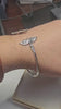 "360-degree view of the Twin Wings 925 sterling silver cuff bracelet. Watch the brilliant mirror polish and intricate bird details come to life in natural light. Masterful craftsmanship by Lakseena Jewelry."