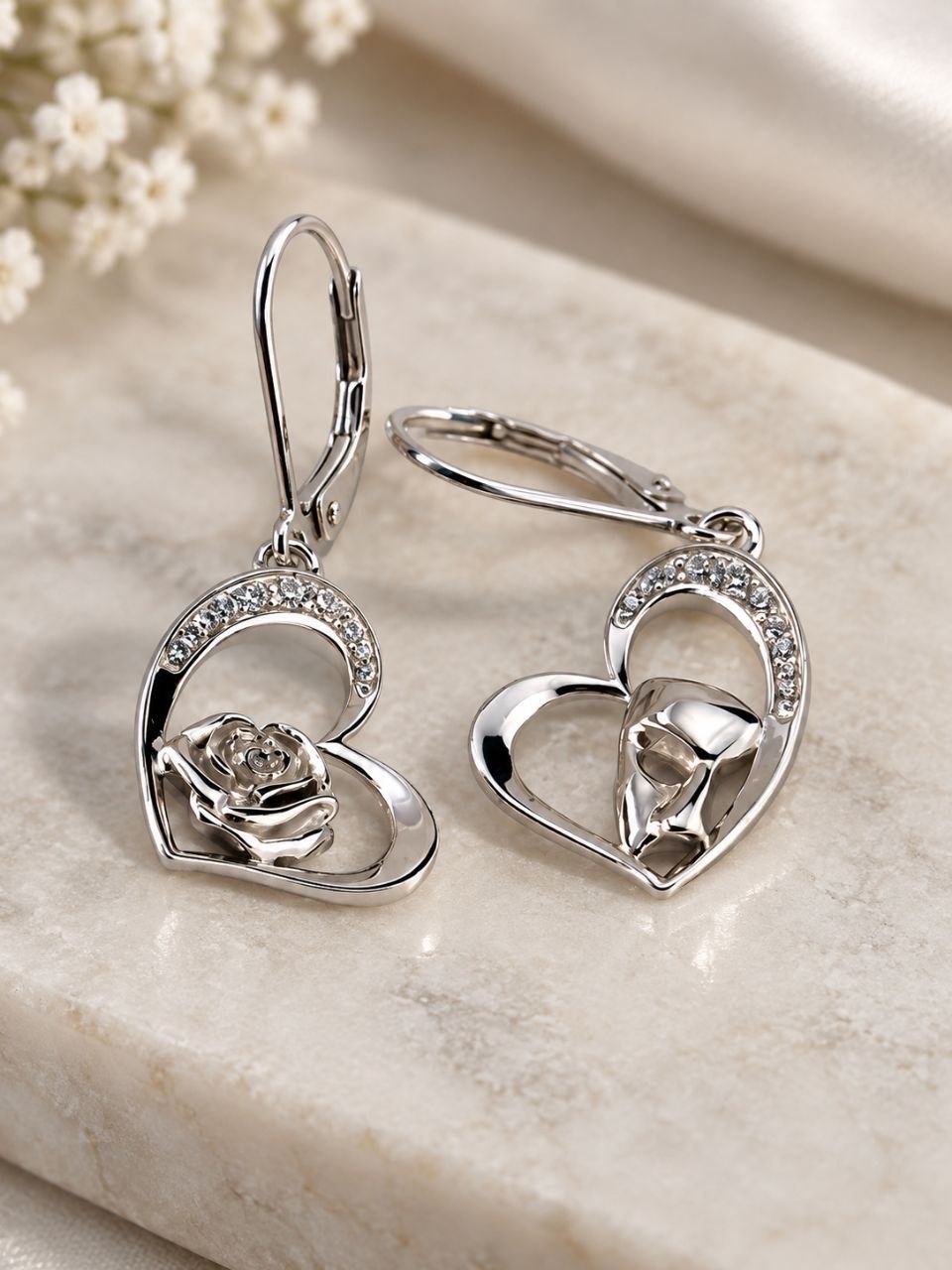 Sterling silver heart earrings with rose and masquerade mask details and sparkling stone accents