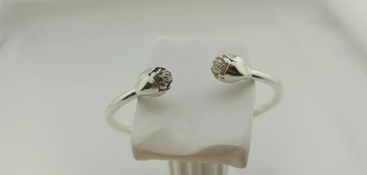 “Rosebud silver cuff bracelet in 925 sterling silver, floral blossom design shown on wrist.”