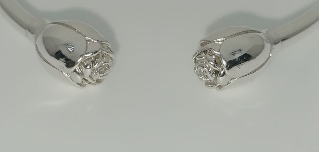 “Close-up of 925 sterling silver rosebud cuff with sculpted blossom bud details.”