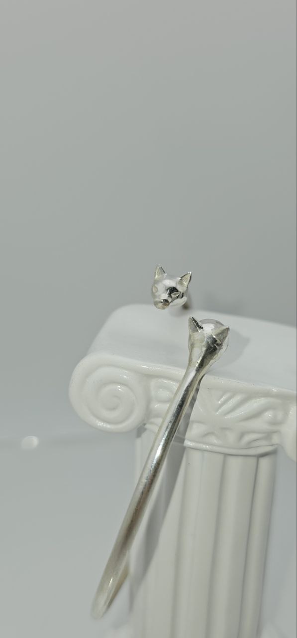 “Silver Cat Bracelet – vertical side view of 925 sterling silver open cuff with cat head detail on a white display stand”