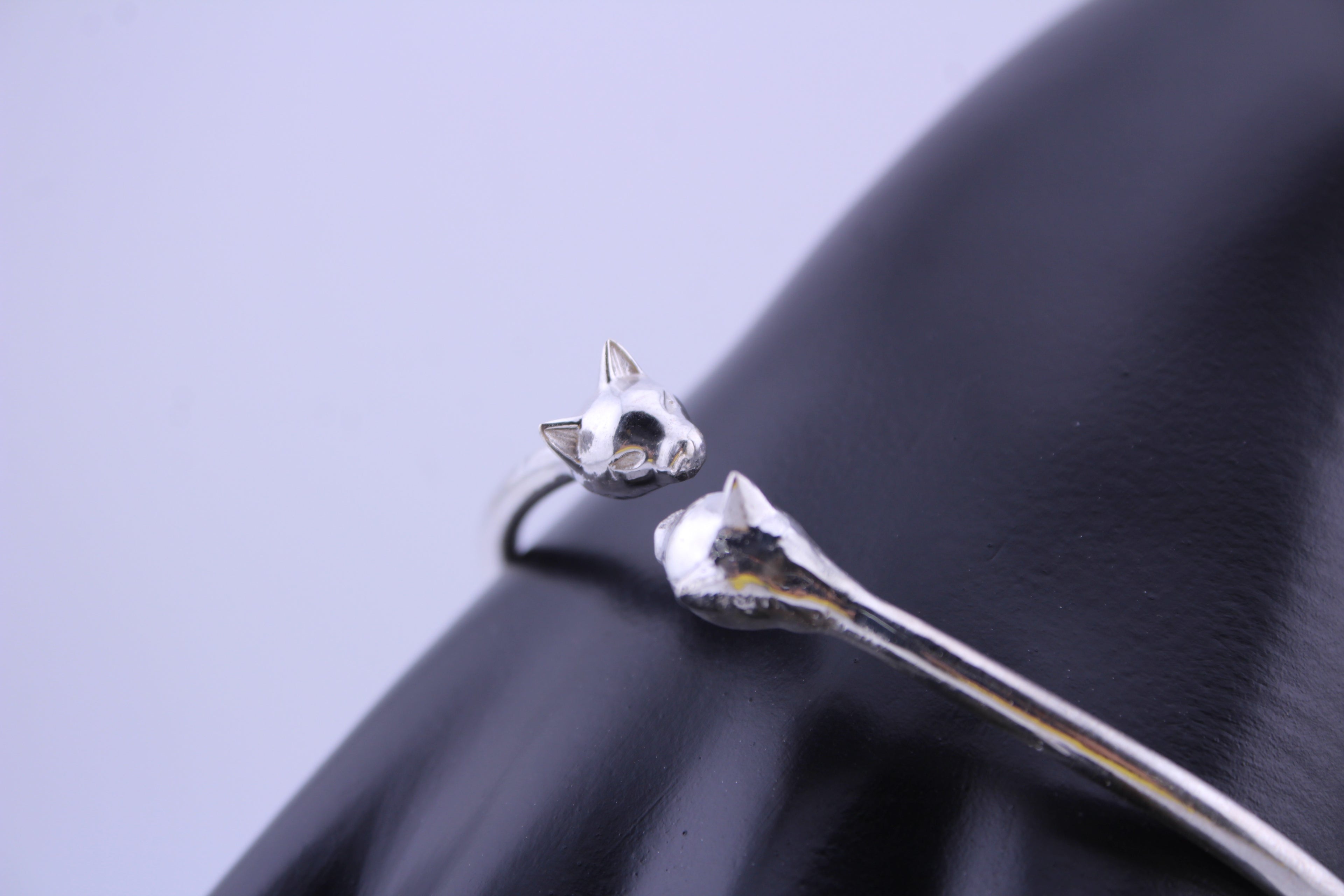 “Silver Cat Bracelet – close-up of 925 sterling silver cat head cuff on a black surface”
