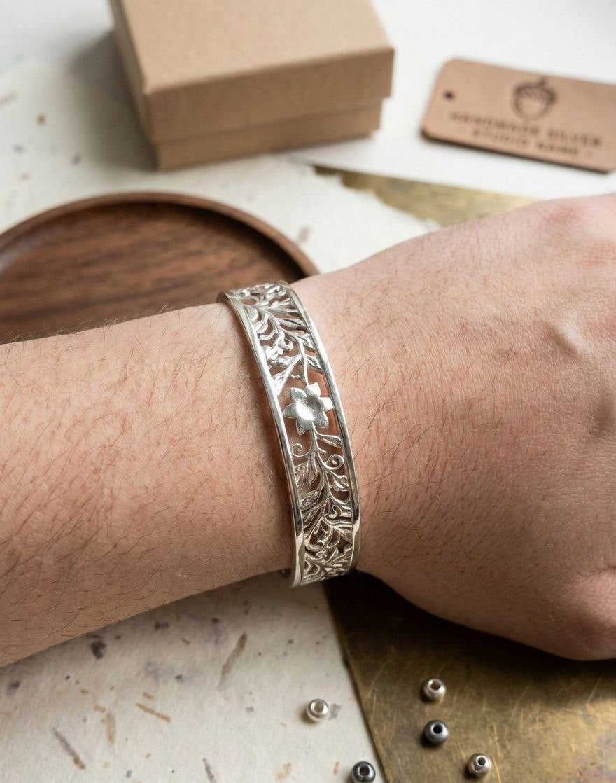 Handcrafted 925 sterling silver floral cuff bracelet shown on a wrist, featuring intricate openwork design and heritage artistry. Elegant jewelry for daily wear by Lakseena.