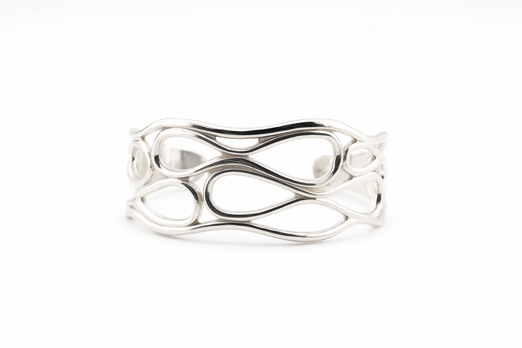 Silver infinity wave cuff bracelet on a clean white background.