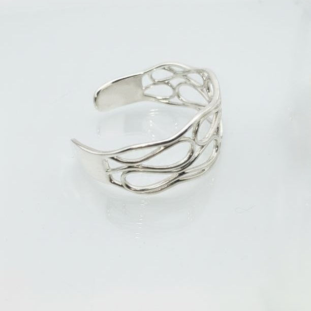 Silver infinity wave cuff bracelet on a white background.