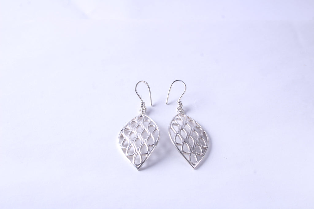 Pair of handcrafted sterling silver leaf earrings with an openwork design on a white background
